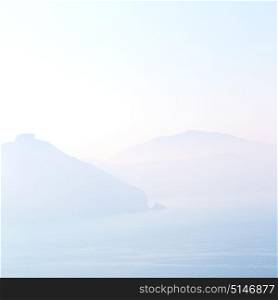 fog in the cyclades sea of greece sun light and backlight from the clouds