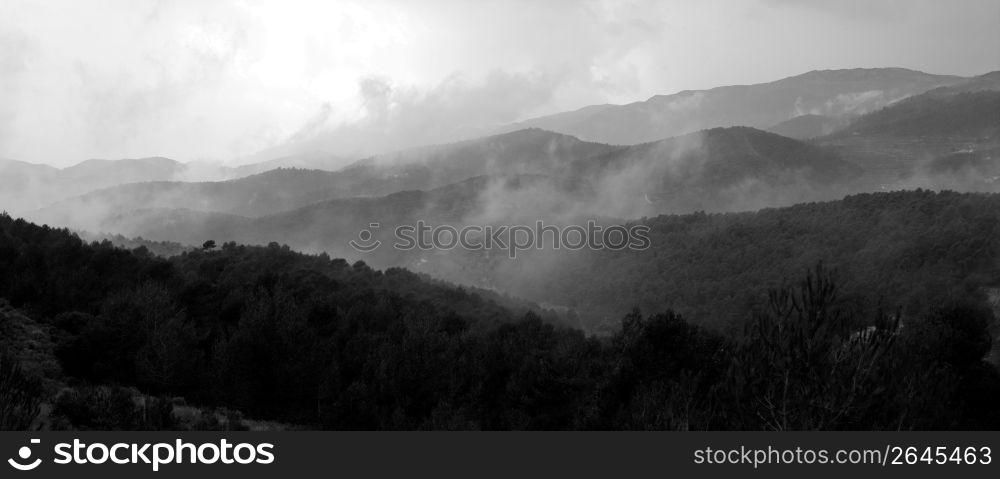 Fog on black and white mountains panorama landscape