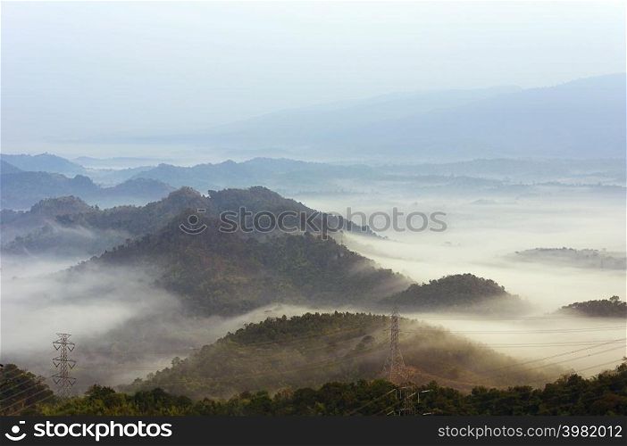 fog on mountain mae moh lampang with High voltage power transmission towers.. Fog in winter
