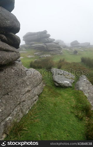 Foggy landscape over Dartmoor National Park with rocky detail