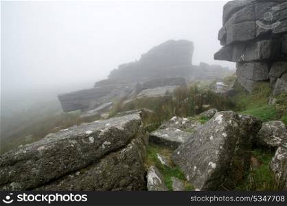 Foggy landscape over Dartmoor National Park with rocky detail
