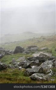Foggy landscape over Dartmoor National Park with rocky detail