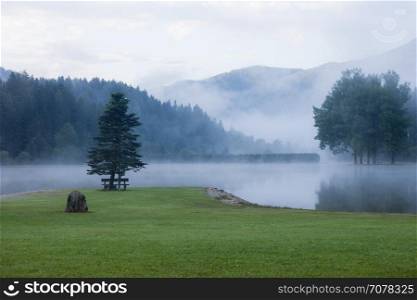 Foggy morning mountain lake