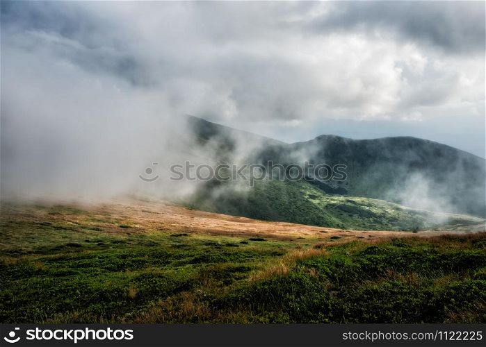 Foggy mountain range during a stormy summer day