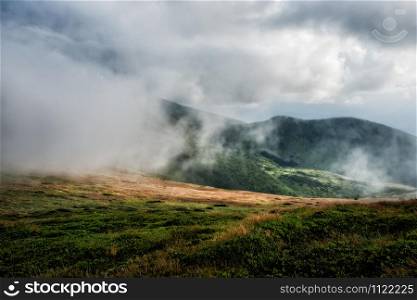 Foggy mountain range during a stormy summer day