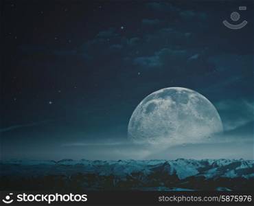 Foggy night with beauty Moon over snowy mountains. NASA imagery used
