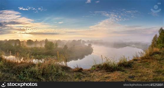 Foggy river in the autumn morning. Panorama