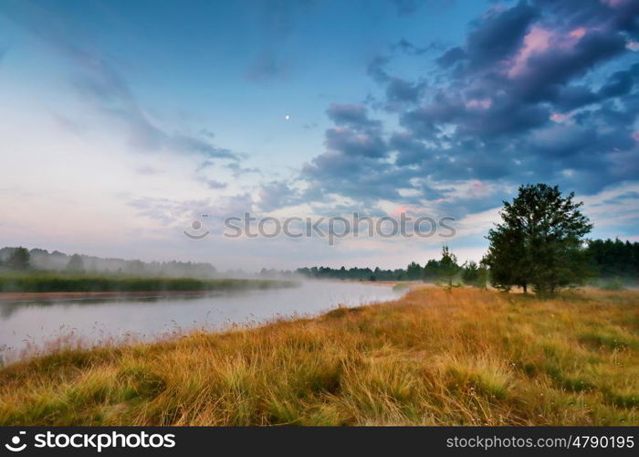 Foggy river in the morning. Misty dawn at summer season. Misty morning scene.