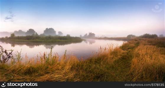 Foggy river in the morning. Panorama. Warm summer morning. Summer misty sunrise panoramic landscape