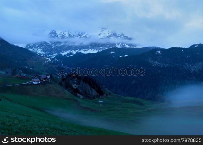 Foggy sunrise over Dolomites mountains. Italian Dolomites