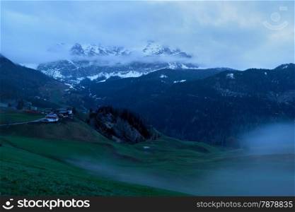 Foggy sunrise over Dolomites mountains. Italian Dolomites