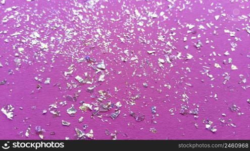 Foil pieces on pink background with multi-colored shine. Abstract fashion macro photo.. Foil pieces on pink background with multi-colored shine. Abstract fashion stock macro photo.