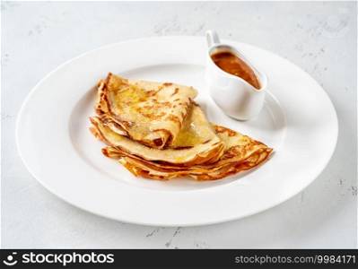 Folded crepes on the white serving plate