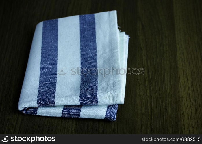 folded napkin on wooden table