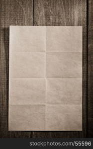 folded note paper on wooden background