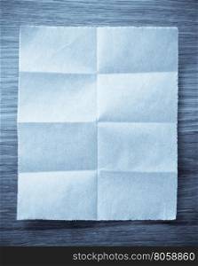 folded note paper on wooden background