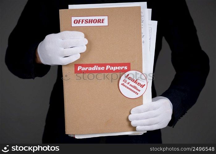 Folder with Paradise Papers and Offshore label with documents inside, tax heaven documents leak concept
