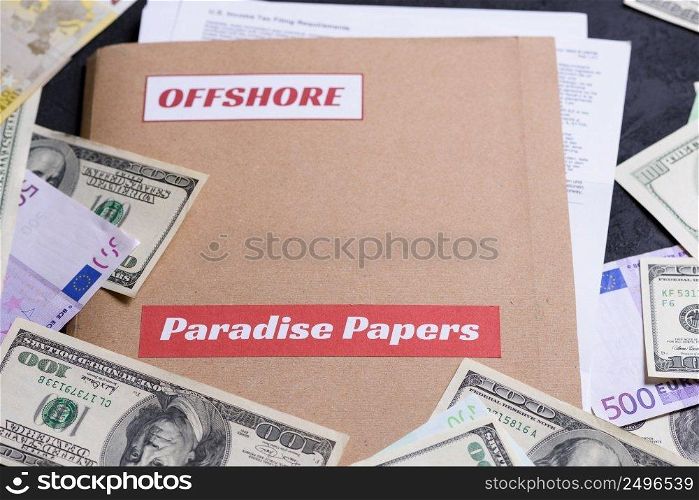 Folder with Paradise papers label on it with european and american currency, offshore tax heaven documents leak concept
