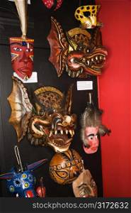 Folk art masks hanging in retail store.