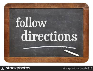 Follow directions sign - white chalk text on a vintage slate blackboard