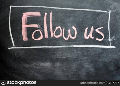 Follow us written on a blackboard