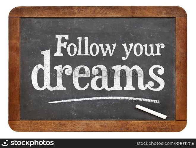Follow your dreams motivational words - white chalk text on a vintage slate blackboard