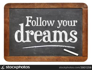 Follow your dreams motivational words - white chalk text on a vintage slate blackboard
