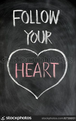 Follow your heart drawn in chalk on a blackboard