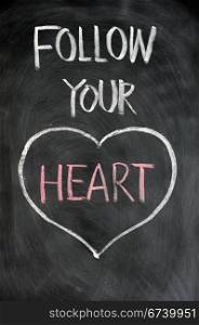 Follow your heart drawn in chalk on a blackboard