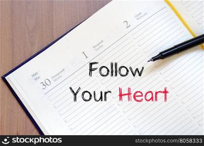 Follow your heart text concept write on notebook