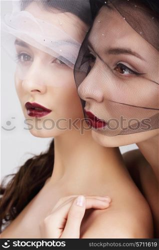 Fondness. Two Females in Veils Embracing