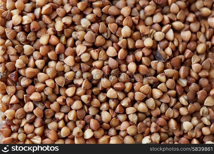 food, agriculture, cereals and healthy eating concept - whole buckwheat grain