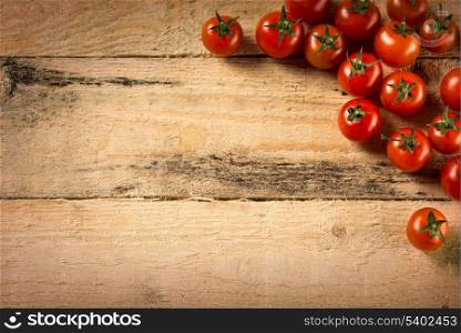 food and cooking concept - cherry tomatoes on wood background