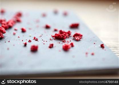 food and cooking concept - dried raspberries or berries on stone plate. dried raspberries or berries on stone plate