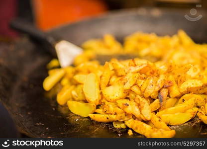 food and cooking concept - fried potato on stir fry pan. fried potato on stir fry pan