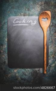Food and cooking rustic background with blank chalkboard , wooden spoon and lettering cooking