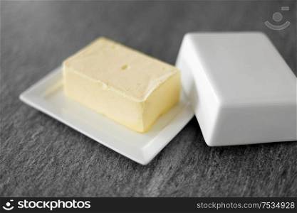 food and dairy products concept - close up of butter on stone table. close up of butter on stone table