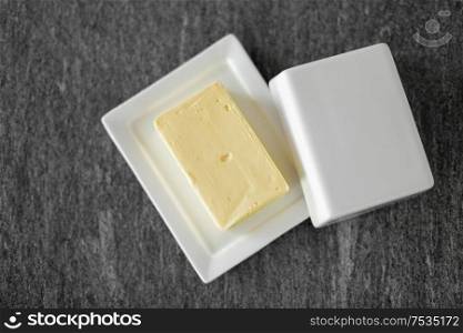 food and dairy products concept - close up of butter on stone table. close up of butter on stone table