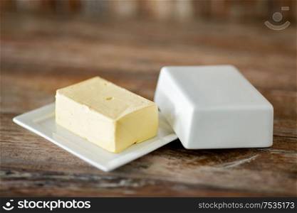 food and dairy products concept - close up of butter on wooden table. close up of butter on wooden table