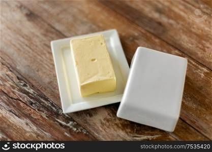 food and dairy products concept - close up of butter on wooden table. close up of butter on wooden table