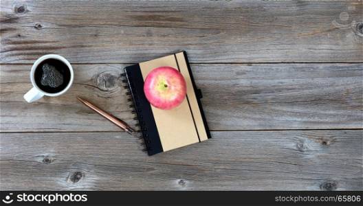 Food and drink with traditional work items on rustic desktop in flat layout view for work or school concept