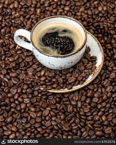 Food and drinks. Black coffee on coffee beans background