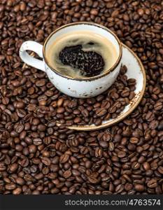 Food and drinks. Black coffee on coffee beans background