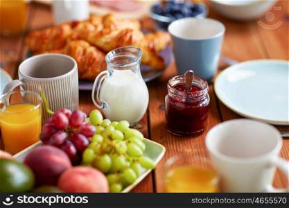 food and eating concept - jar with jam on wooden table at breakfast. jar with jam on wooden table at breakfast