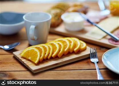 food and eating concept - sliced orange and other food on wooden table. sliced orange and other food on wooden table