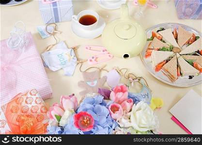 Food and Flowers on a Table at a Baby Shower