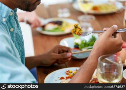 food and people concept - close up of man eating vegetables with fork. close up of man with fork eating vegetables