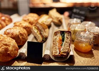food and sale concept - bread and craft sandwiches with price tags at grocery store. bread and sandwiches with price at grocery store