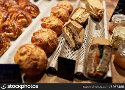food and sale concept - bread, buns, pies and sandwiches with price tags at grocery store. bread and sandwiches with price at grocery store
