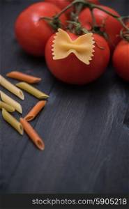food background . food background on rustic wood with pasta and tomatoes